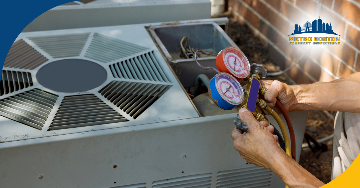 Technician checking HVAC system pressure with colorful gauges outdoors next to a large air conditioning unit and brick wall.