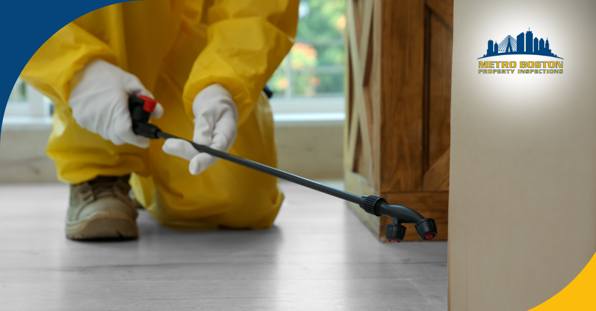 Pest control technician in yellow protective suit applying indoor treatment.