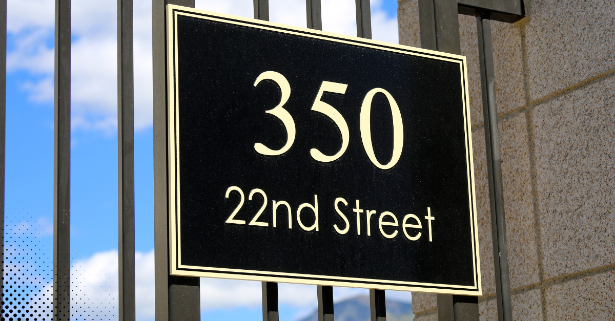 Black sign with white text showing address 350 22nd Street