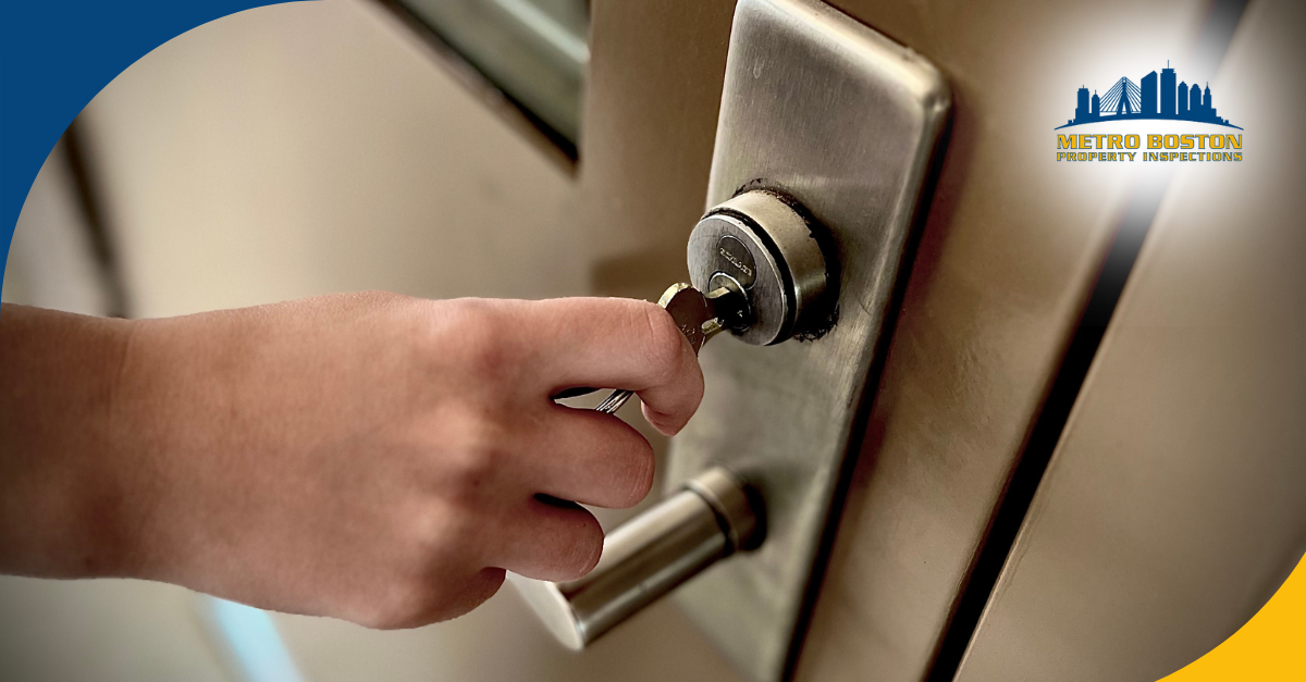 Hand inserting a key into a door lock.