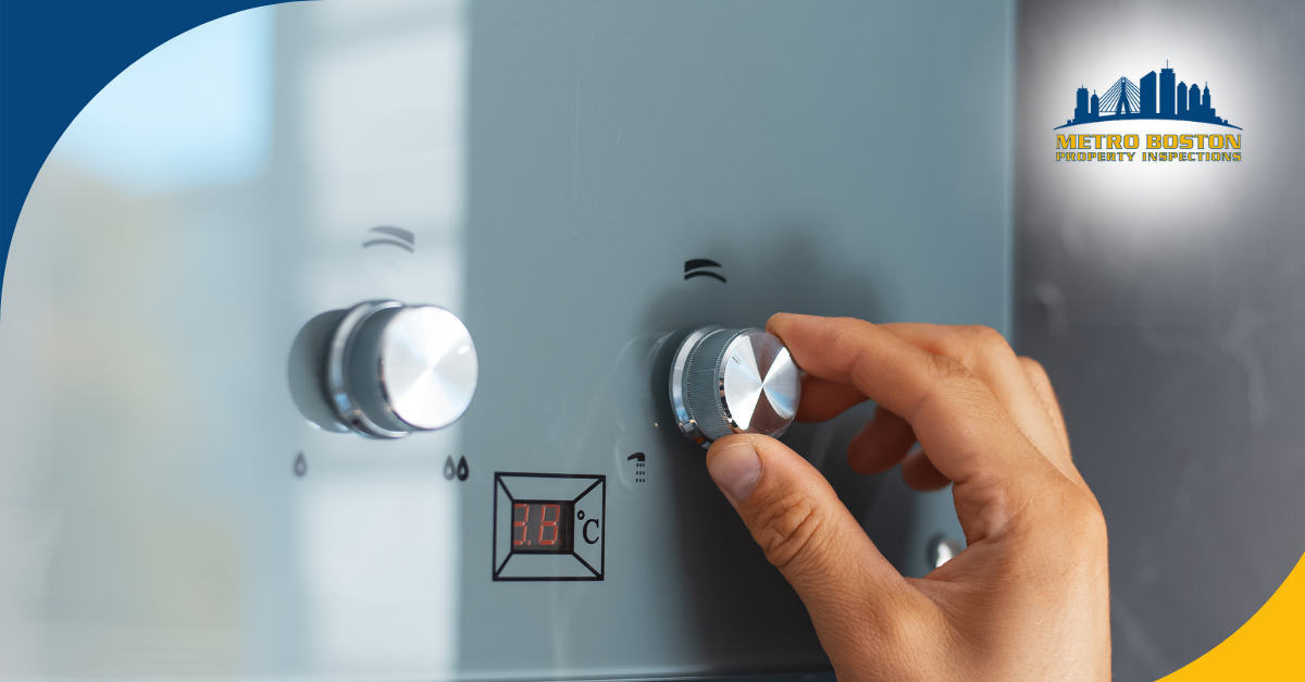 Hand adjusting the temperature knob on a water heater.