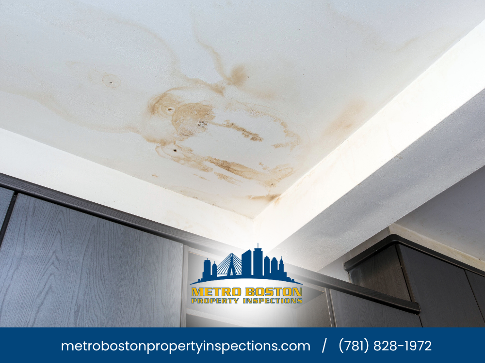 Water damage stain on the ceiling in a home, likely due to a leaky roof or plumbing issue.